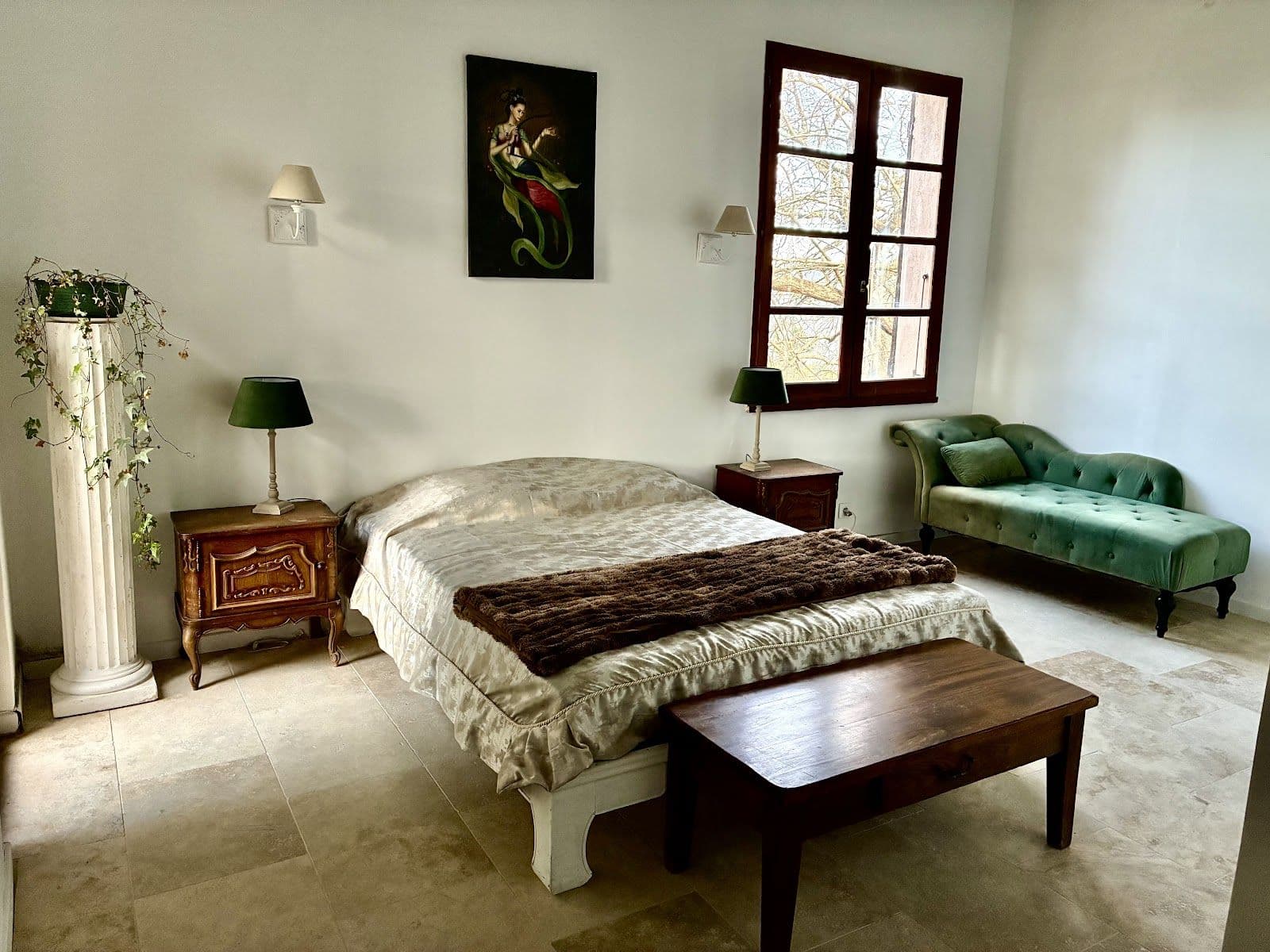 A bedroom at the estate with a double bed and views of the trees